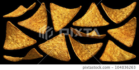 Falling corn chips, hot Mexican nachos isolated on black background Falling corn chips, hot Mexican nachos isolated on black background 104836263