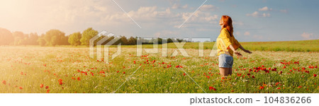 Woman in profile standing on the field with a lot of wild flowers Woman in profile standing on the field with a lot of wild flowers 104836266