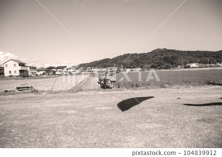 Agricultural machinery and shadows of umbrellas 104839912