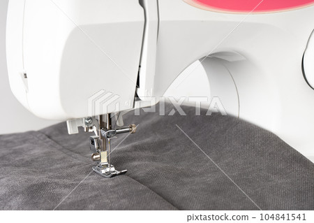 Modern sewing machine with gray fabric 104841541