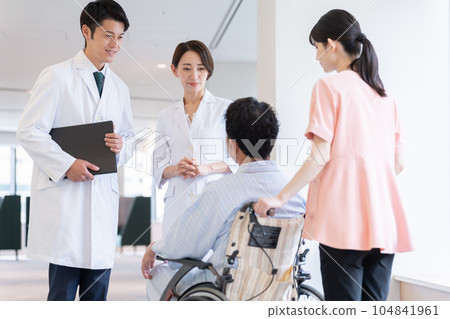 Doctor talking to inpatient in wheelchair in hospital Doctor talking to inpatient in wheelchair in hospital 104841961