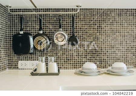 Group of kitchenware arrangement at the corner of the kitchen in hotel suite room. The household kitchen was designed for preparing and cooking meals. 104842219