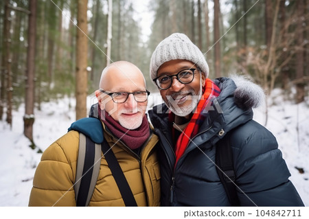 Active retired interracial gay couple hiking in forest, winter season outdoors. Generative AI 104842711