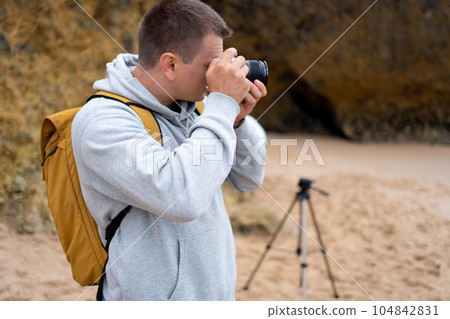 Traveler photographer takes photo beautiful seascape 104842831