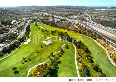 Drone point of view golf course during sunny summer day Drone point of view golf course during sunny summer day 104843082