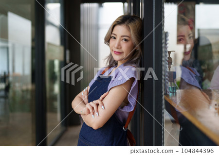 Asian cafe owner or barista standing with smiling at cafe. woman small business owner in food and beverage Asian cafe owner or barista standing with smiling at cafe. woman small business owner in food and beverage 104844396