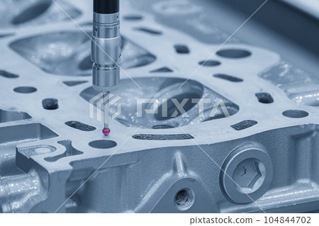 The CMM machine measuring the aluminum cylinder head parts . 104844702