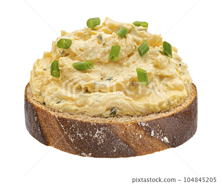 Egg spread with onion and chives on rye bread isolated on white background Egg spread with onion and chives on rye bread isolated on white background 104845205