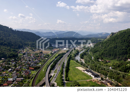 Autobahn in the Alps, beautiful view from above the city and the road Autobahn in the Alps, beautiful view from above the city and the road 104845220