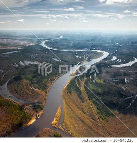 The mouth of the river in the tundra. Tributaries of the river. Landscape view from above. The mouth of the river in the tundra. Tributaries of the river. Landscape view from above. 104845223