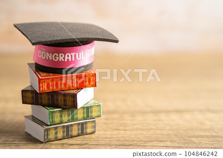 Graduation hat on book with copy space, learning university education concept. Graduation hat on book with copy space, learning university education concept. 104846242