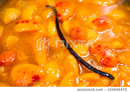 Apricot jam cooking with a vanilla pod Apricot jam cooking with a vanilla pod 104846478