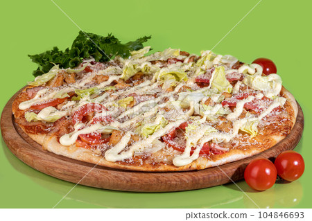 Pizza with bacon cheese and herbs on a wooden plate with cheese and cherry tomatoes. On a colored Pizza with bacon cheese and herbs on a wooden plate with cheese and cherry tomatoes. On a colored 104846693