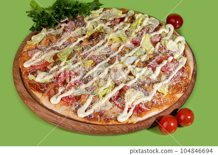 Pizza with bacon cheese and herbs on a wooden plate with cheese and cherry tomatoes. On a colored Pizza with bacon cheese and herbs on a wooden plate with cheese and cherry tomatoes. On a colored 104846694