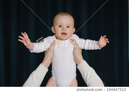 Baby boy smile when his father picked him up in his arms 104847312