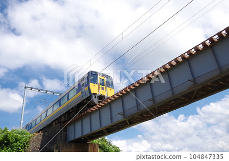 Limited express train crossing the iron bridge 104847335