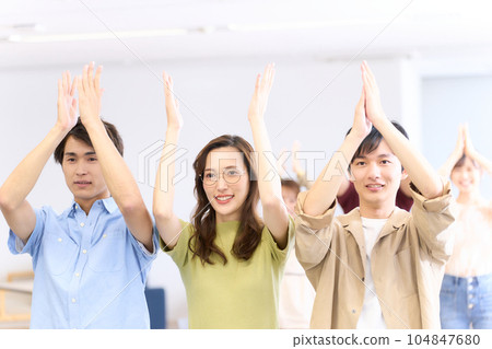 Young man and woman clapping with a smile Seminar off-party image Young man and woman clapping with a smile Seminar off-party image 104847680