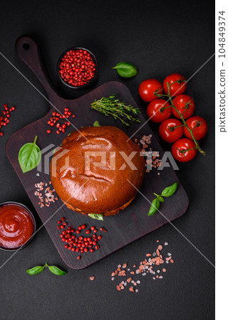 Burger with juicy beef cutlet, cheese, tomatoes, salt, spices and herbs Burger with juicy beef cutlet, cheese, tomatoes, salt, spices and herbs 104849374