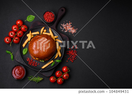 Burger with juicy beef cutlet, cheese, tomatoes, salt, spices and herbs Burger with juicy beef cutlet, cheese, tomatoes, salt, spices and herbs 104849431