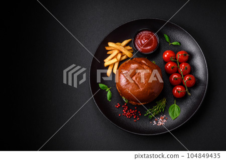Burger with juicy beef cutlet, cheese, tomatoes, salt, spices and herbs Burger with juicy beef cutlet, cheese, tomatoes, salt, spices and herbs 104849435
