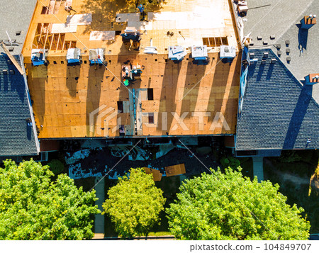 During repair roof an apartment building were installed new shingles and plywood was replace old ones During repair roof an apartment building were installed new shingles and plywood was replace old ones 104849707