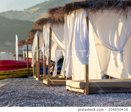 White beach canopies. Luxury beach tents at a resort. Beach concept 104850438