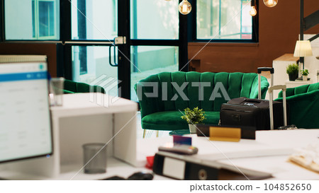Empty hotel lobby with lounge area and reception desk used to help guests with check in procedure, resort entrance with luxury interior design. Modern front desk with accomodations. 104852650