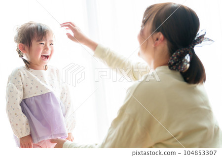 Girl playing with mom 104853307