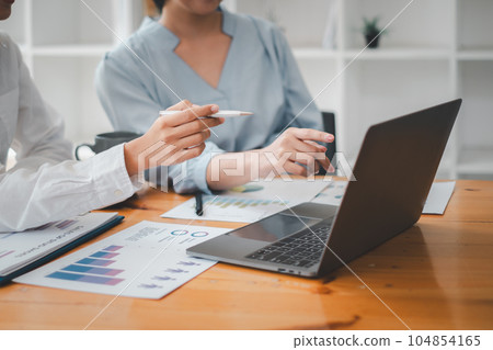 Asian business adviser meeting to analyze and discuss the situation on the financial report in the meeting room, Financial advisor and accounting concept 104854165