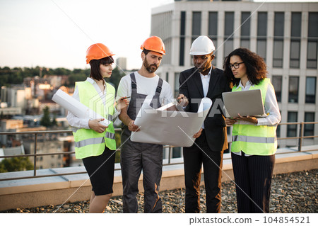 Diverse building engineers brainstorming for common project Diverse building engineers brainstorming for common project 104854521