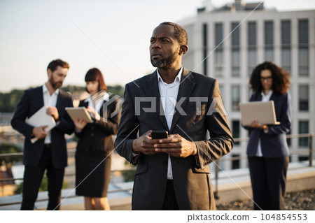 Business investors with gadgets in hands controlling work 104854553