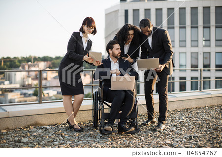 Global experts with gadgets talking about construction plan 104854767
