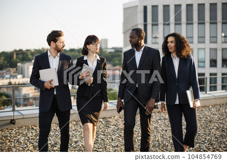 Diverse business partners walking after work conference Diverse business partners walking after work conference 104854769