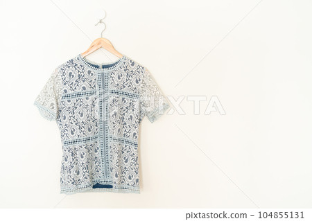 beautiful woman shirt hanging on wall beautiful woman shirt hanging on wall 104855131
