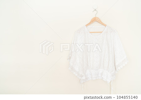 beautiful woman shirt hanging on wall 104855140