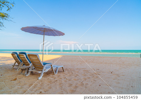 beach chair on sand with ocean sea background beach chair on sand with ocean sea background 104855459