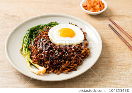 dried Korean spicy black sauce instant noodles with fried egg and kimchi dried Korean spicy black sauce instant noodles with fried egg and kimchi 104855488