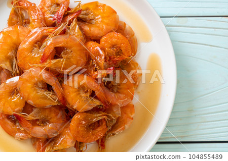 Sweet shrimps is Thai dish which cooks with fish sauce and sugar Sweet shrimps is Thai dish which cooks with fish sauce and sugar 104855489