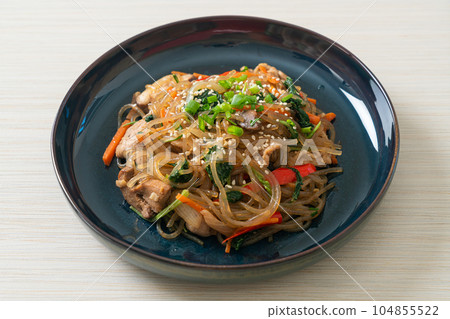 japchae or stir-fried Korean vermicelli noodles with vegetables and pork topped with white sesame japchae or stir-fried Korean vermicelli noodles with vegetables and pork topped with white sesame 104855522