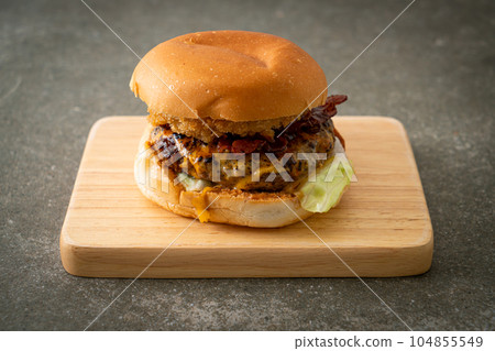 beef burger with cheese, bacon and onion rings 104855549