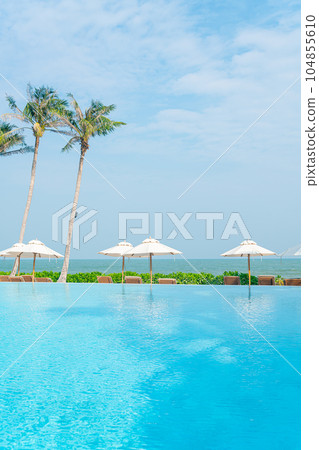 umbrella with bed pool around swimming pool with ocean sea background umbrella with bed pool around swimming pool with ocean sea background 104855610