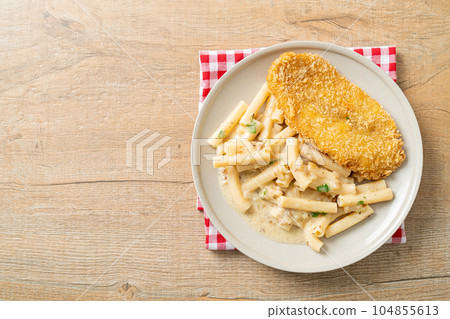 quadrotto penne pasta white cream sauce with fried fish 104855613