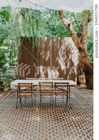 empty wood chair and table in garden 104855799