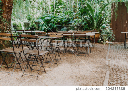 empty wood chair and table in garden 104855886