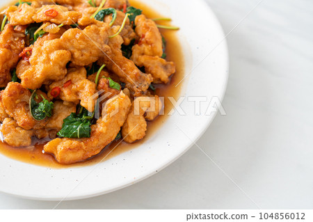 stir-fried fried fish with basil and chili in thai style stir-fried fried fish with basil and chili in thai style 104856012