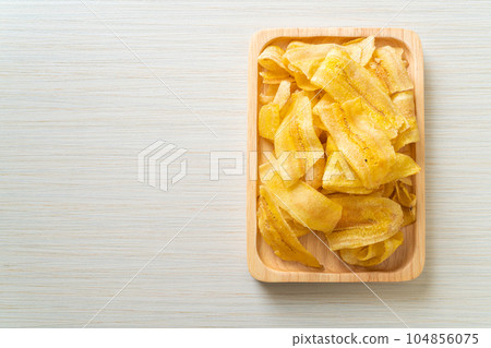 Banana Chips - fried or baked sliced banana 104856075