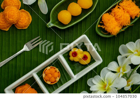 Thai traditional dessert concept, Assorted Thai dessert served in a plate on banana leaf background 104857030