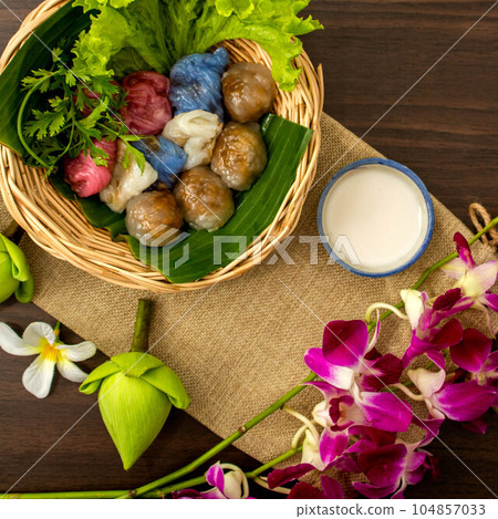 Thai dessert concept, Thai coconut milk custard and tapioca balls with pork filling on basket Thai dessert concept, Thai coconut milk custard and tapioca balls with pork filling on basket 104857033
