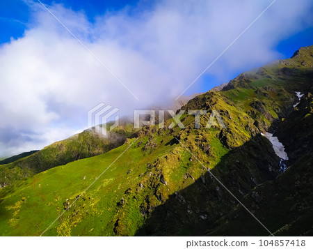 Beautiful mountain landscape with clouds in the sky 104857418
