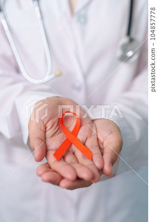 Orange Ribbon for Leukemia, Kidney cancer day, world Multiple Sclerosis, CRPS, Self Injury Awareness month. Healthcare and word cancer day concept 104857778